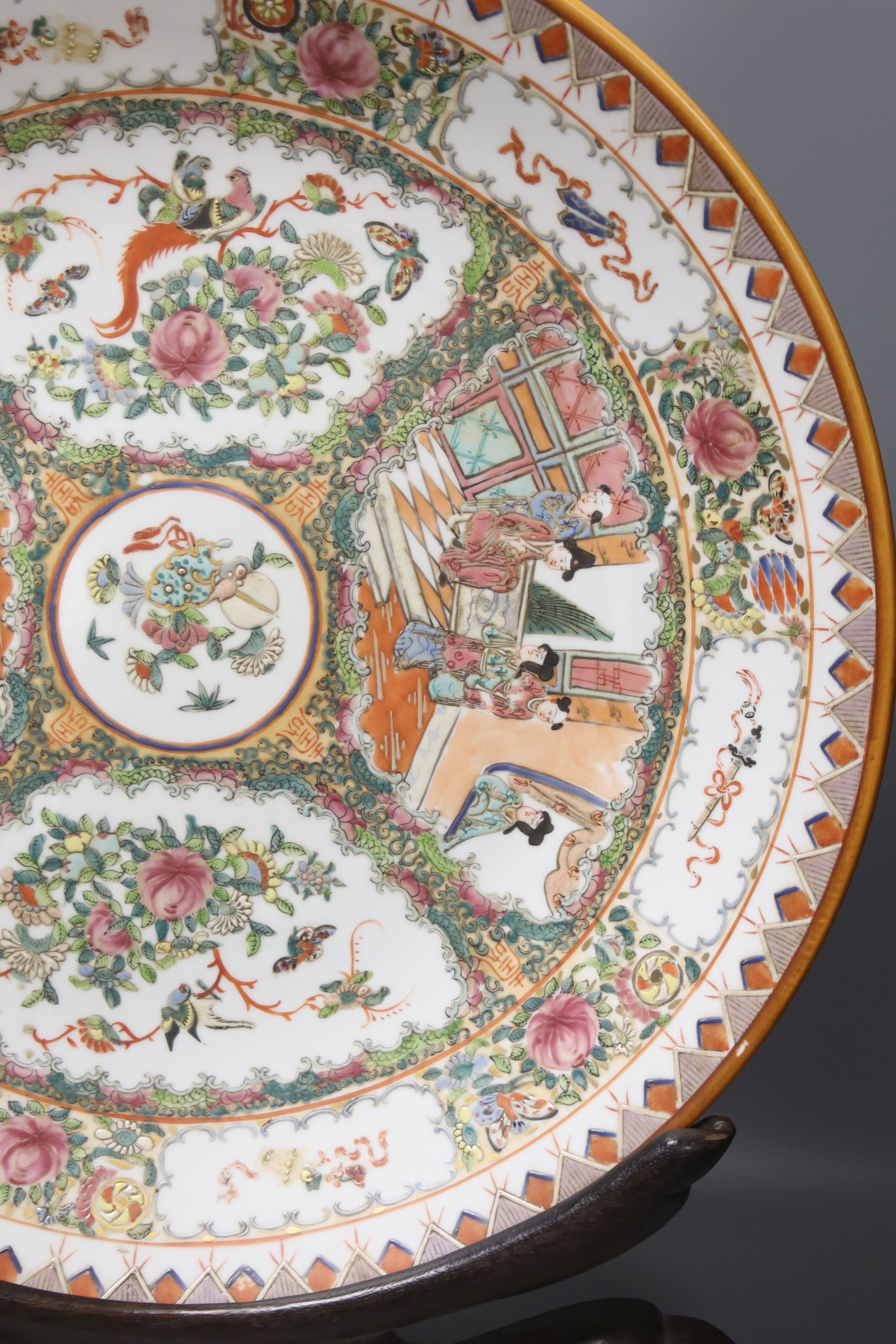 A large 20th century Chinese famille rose porcelain charger, diameter 46cm, on hardwood stand